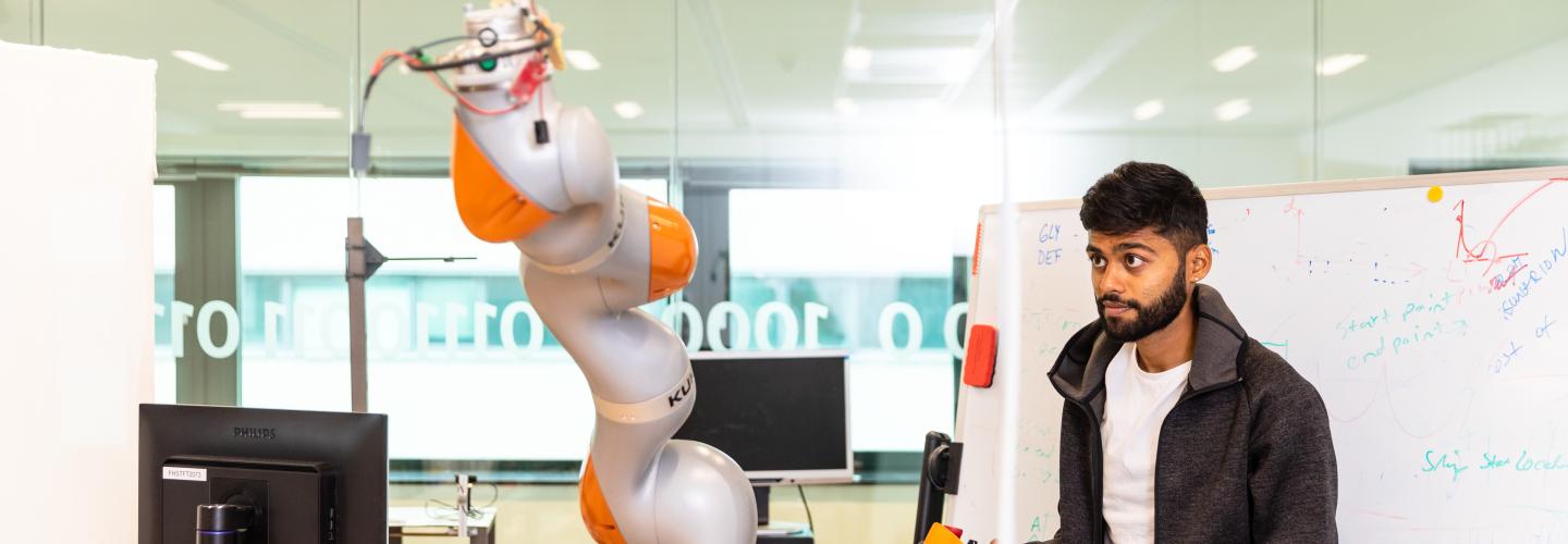 Guy working with robot arm