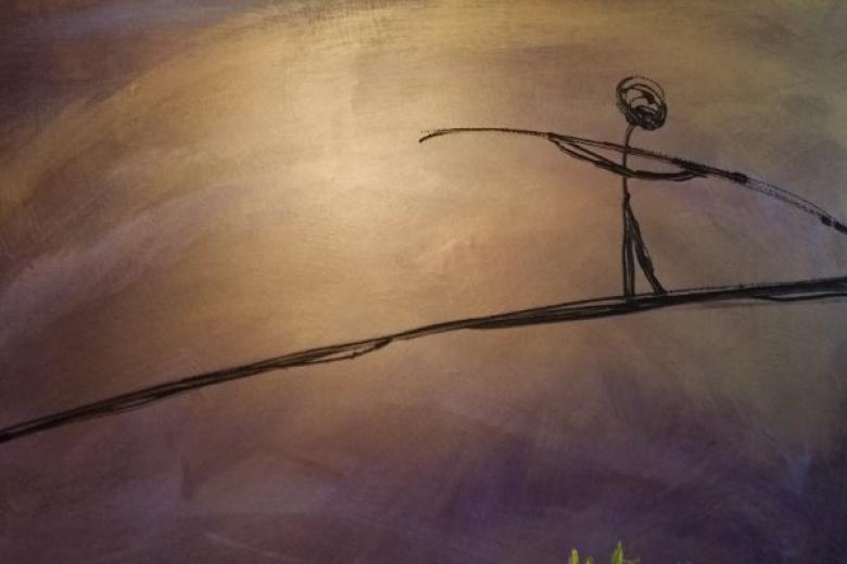 A stickfigure walking a tightrope