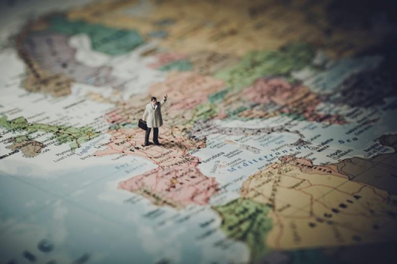 European Public Health: doctor doll stands on map of Europe