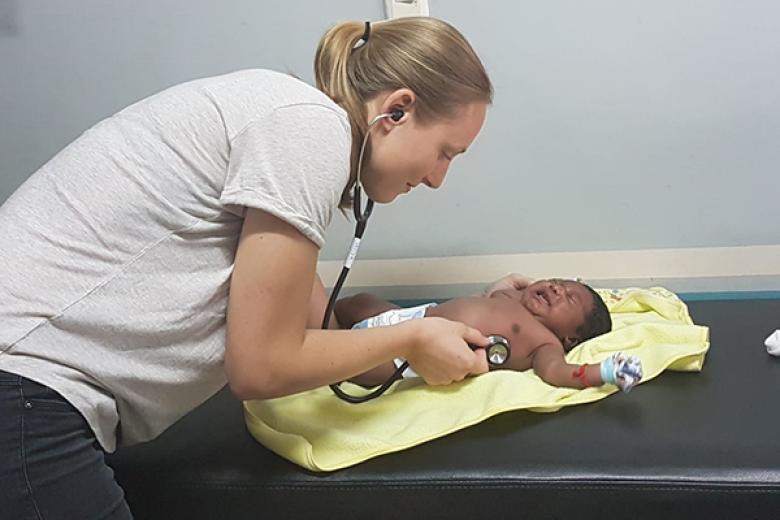 Maastricht University medicine student inspects a baby during her clinical internship in Ecuador