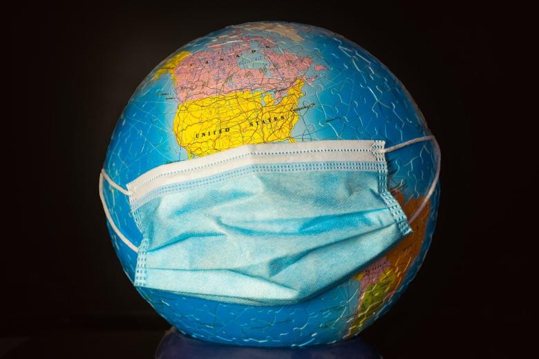 Master global health represented by a globe with a surgical mouth mask