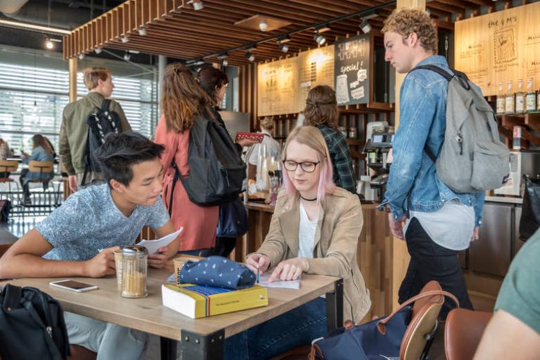 Two students studying together in a cafe at the health campus of Maastricht University