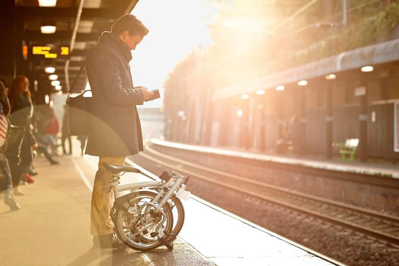 A man waiting on the platform for the train.