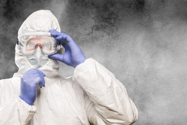 Doctor with protective suit and face mask