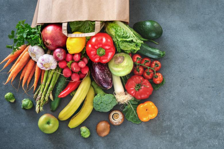 A grocers' bag full of vegetables