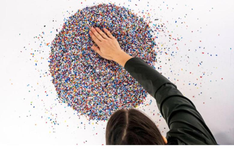 Young woman examining plastic granules