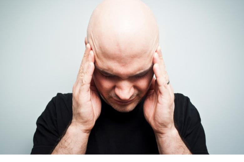 Man holding his head in distress