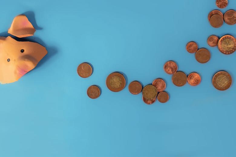 Broken piggy bank with euro coins