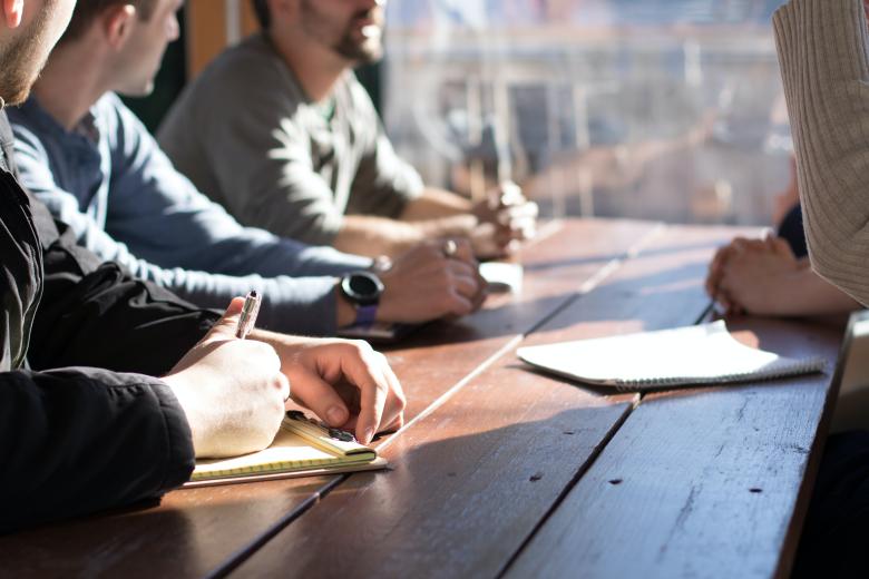 4 people sitting around a table