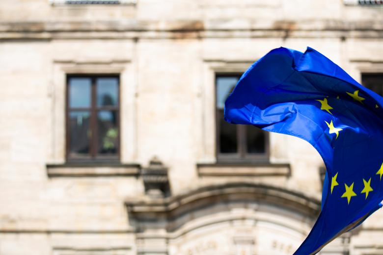 European Flag waving in the wind in front of a building