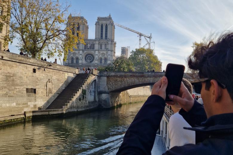 CES student taking a photo of the Notre Dame in Paris