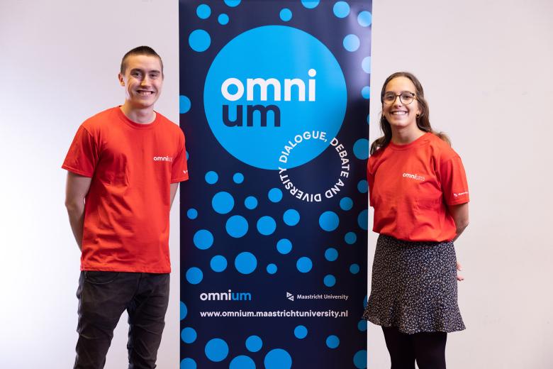 Two OmniUM volunteers standing next to a sidewinder