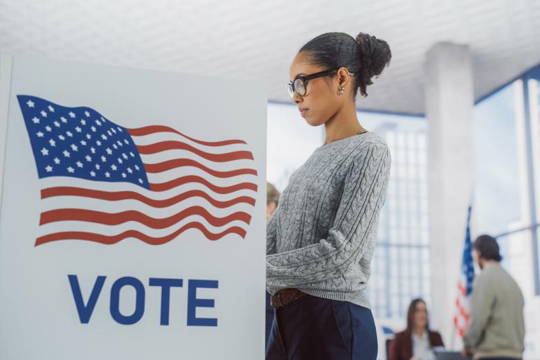 Young woman casting her vote during US elections