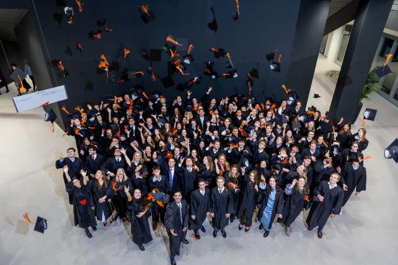 SBE graduates throwing their caps in the air