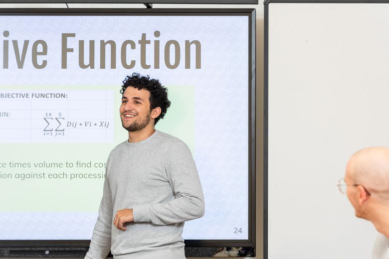 A student giving a presentation about objective function