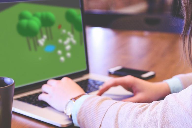 Student playing golf game on laptop