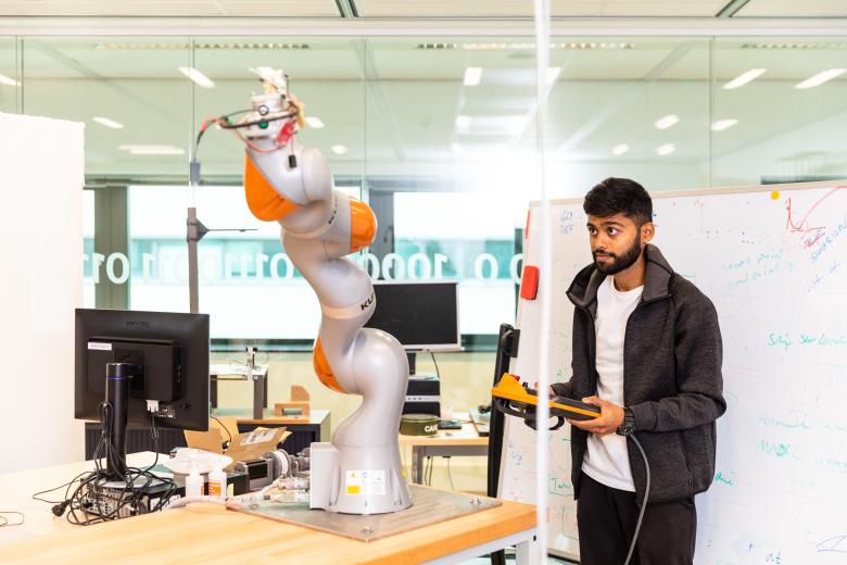 Guy working with robot arm
