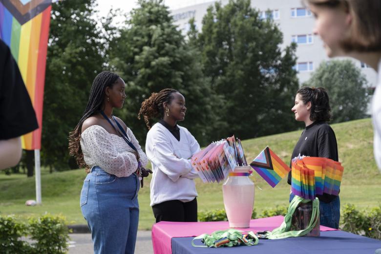 Staff and students talking about Pride month at Pride Month flag raising event