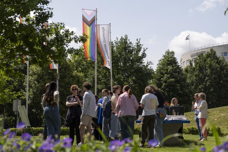Staff and students talking about Pride month at Pride Month flag raising event