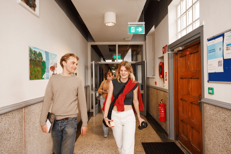 Students walking through university corridor
