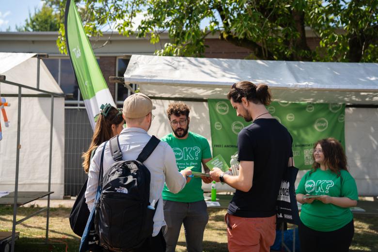 Students receive flyers from @ease, a place they can go if they are not doing so well.