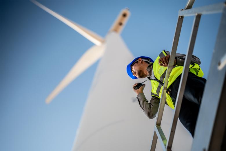 Engineer talking on the phone near a windmill
