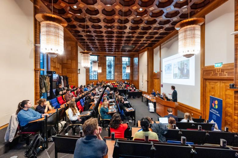 a room with people listening to a lecture