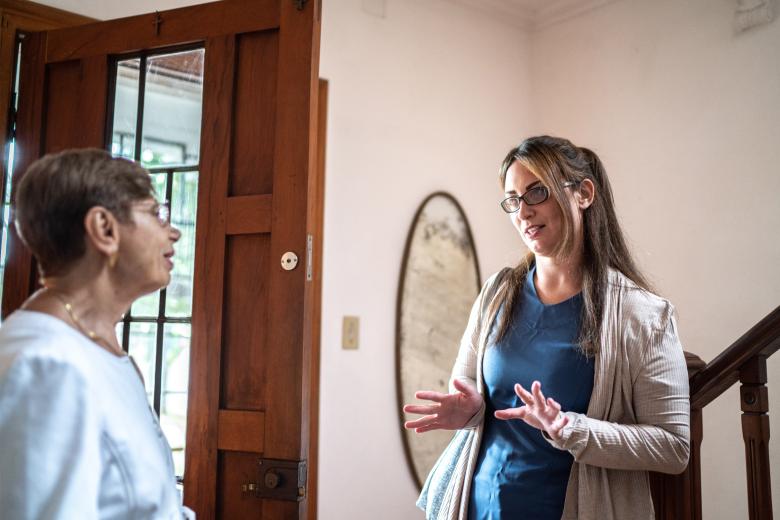 Volunteer interviewing a patient at her home