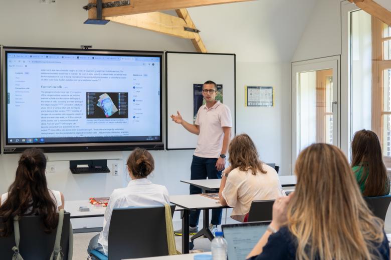 CES students and their professor in a UM classroom