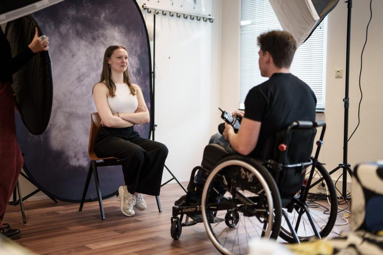 Woman getting her photo taken by guy in wheelchair