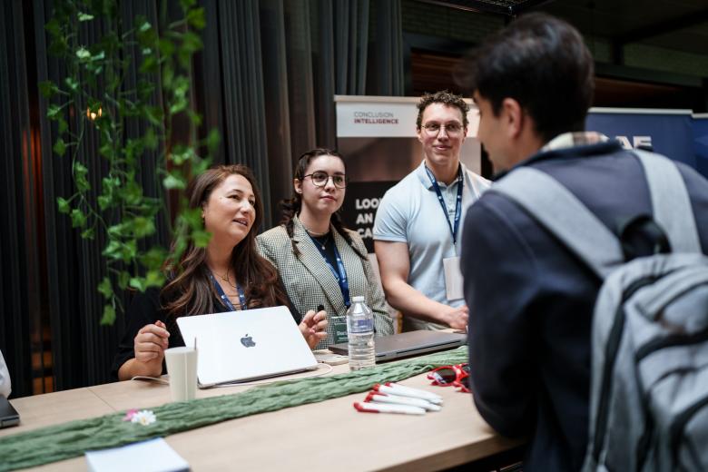 People behind booth on career fair