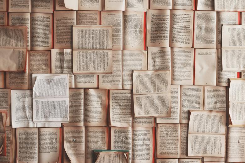 flat lay of diverse books laying open on a flat surface