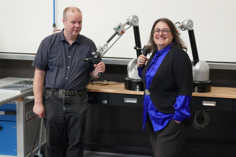 Rico Mockel Celine Nicole posing with two robot arms at BHTA