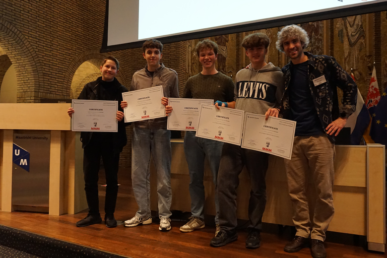 Students posing with cheque after winning contest